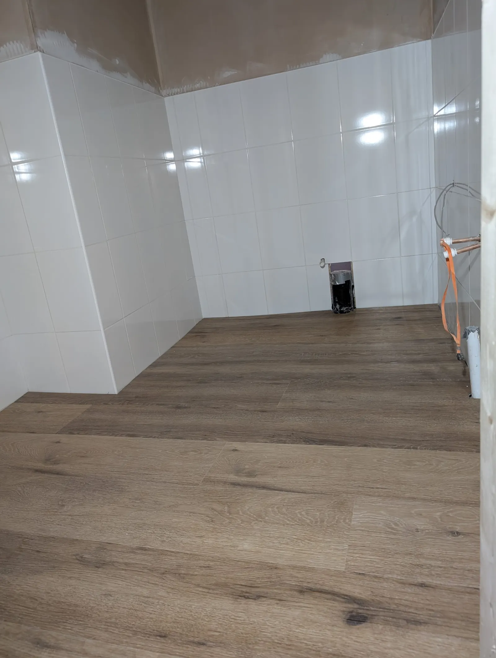 One of the new toilets mid-fit, plumbing in place ahead of tiling and fittings