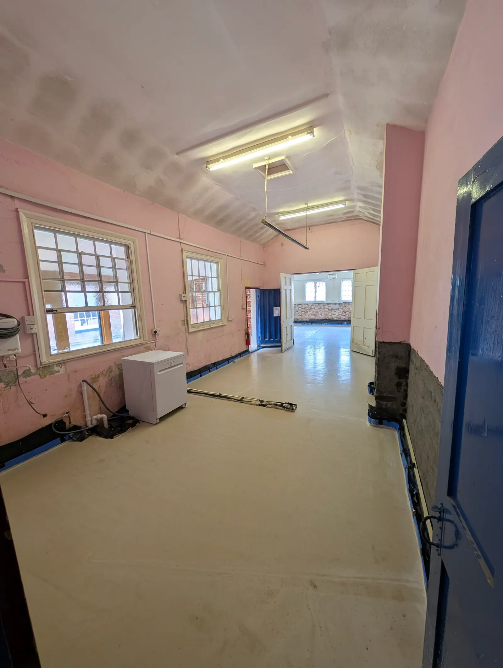 The hall corridor with its new floor, seen through the newly painted hall doorway