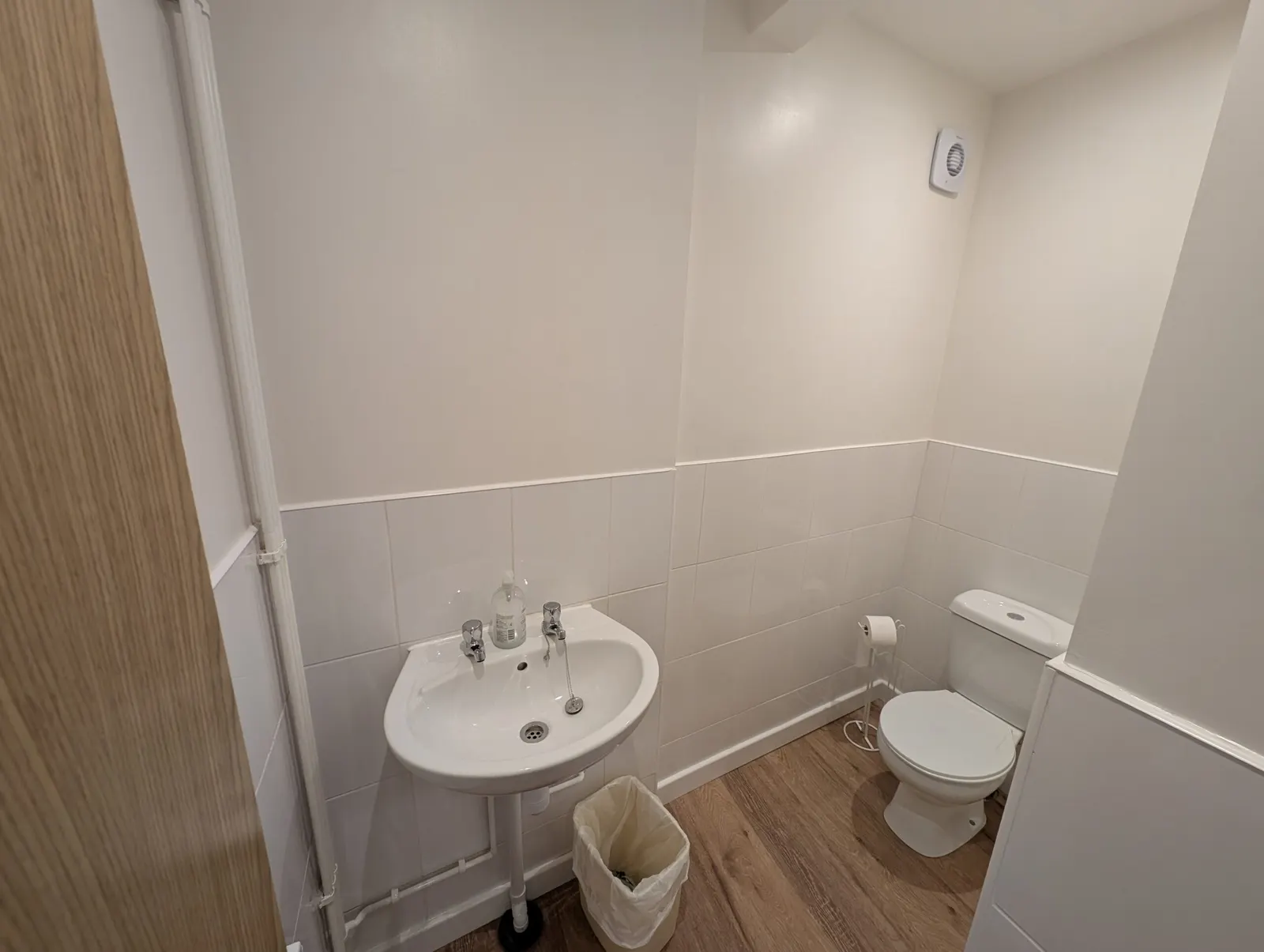 One of the newly tiled toilets, with sink and WC